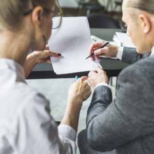 close-up-two-businesspeople-checking-document-restaurant Close up two businesspeople checking document restaurant